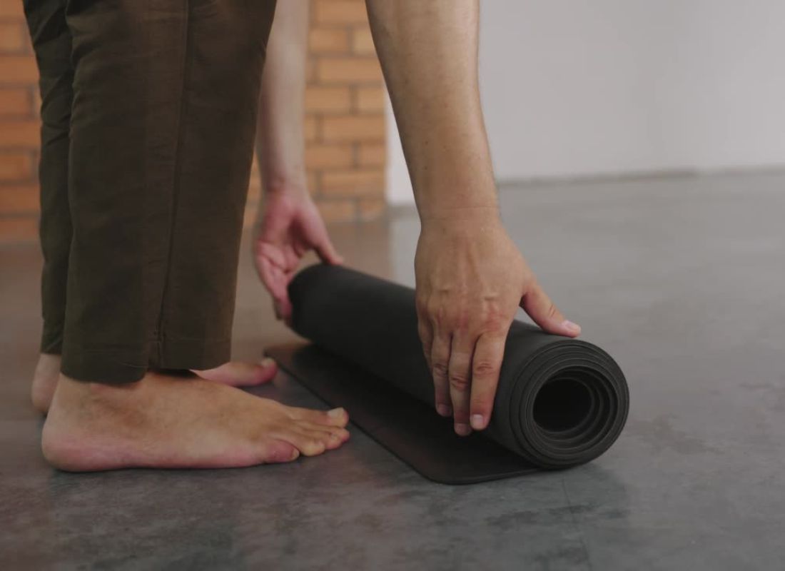 devojka prostire joga prostirku na pod